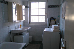 Bathroom with tub and washing machine